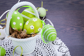 Image showing Colourful green Easter eggs in straw