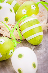 Image showing Colourful green Easter eggs in straw