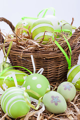 Image showing Colourful green Easter eggs in straw