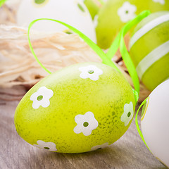 Image showing Colourful green Easter eggs in straw