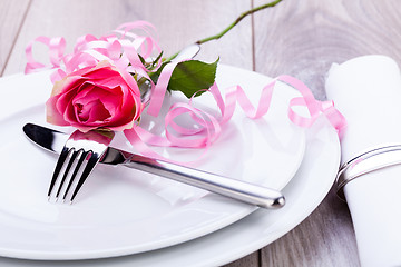 Image showing Table setting with a single pink rose