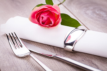 Image showing Table setting with a single pink rose