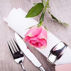 Image showing Table setting with a single pink rose