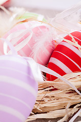 Image showing colorful easter egg decoration on wooden background