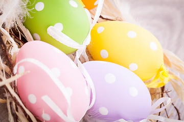 Image showing colorful easter egg decoration on wooden background