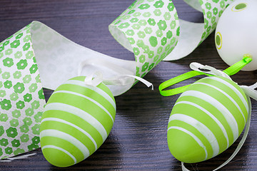 Image showing Colourful green Easter eggs in straw