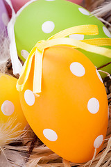 Image showing colorful easter egg decoration on wooden background