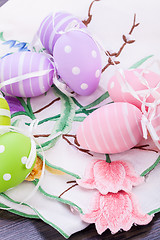 Image showing colorful easter egg decoration on wooden background