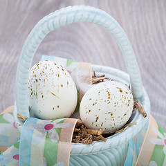 Image showing Three natural blue Easter eggs in a basket