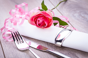 Image showing Table setting with a single pink rose