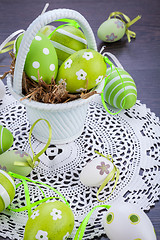 Image showing Colourful green Easter eggs in straw