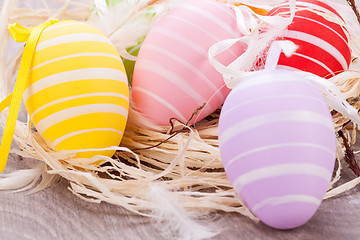 Image showing colorful easter egg decoration on wooden background