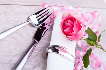 Image showing Table setting with a single pink rose