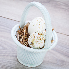 Image showing Three natural blue Easter eggs in a basket