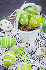 Image showing Colourful green Easter eggs in straw