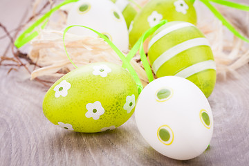 Image showing Colourful green Easter eggs in straw