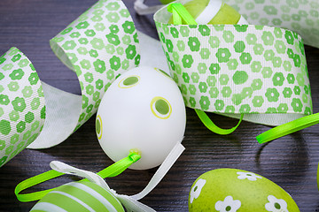 Image showing Colourful green Easter eggs in straw