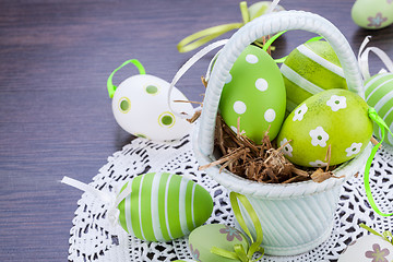 Image showing Colourful green Easter eggs in straw