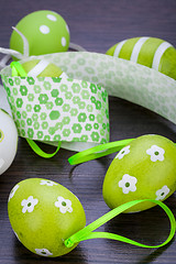 Image showing Colourful green Easter eggs in straw