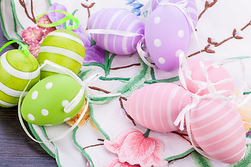 Image showing colorful easter egg decoration on wooden background