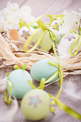 Image showing Colourful green Easter eggs in straw