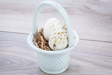 Image showing Three natural blue Easter eggs in a basket