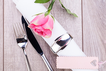 Image showing Table setting with a single pink rose