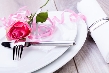 Image showing Table setting with a single pink rose