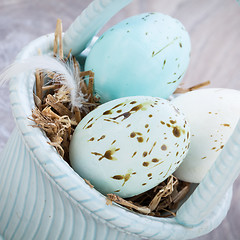 Image showing Three natural blue Easter eggs in a basket