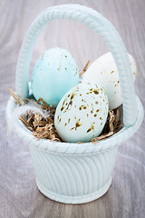 Image showing Three natural blue Easter eggs in a basket