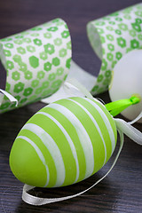 Image showing Colourful green Easter eggs in straw