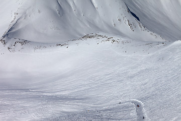 Image showing Snowboarders and skiers on slope and off-piste slope with trace 