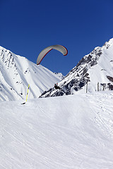 Image showing Skydiver landing on ski slope at nice sun day