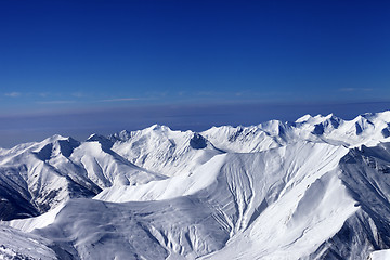 Image showing View on off-piste slopes and multicolor blue sky at nice sunny d