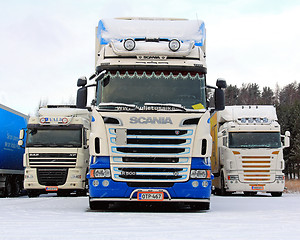 Image showing Three Long Haulage Trucks in Snowfall