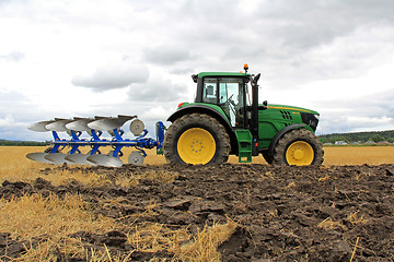 Image showing John Deere 6150M Tractor with a Plow on a Field