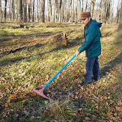 Image showing Elderly worker running in the park in october