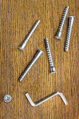 Image showing Screws for assembling furniture and simple tool