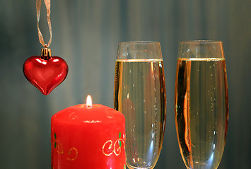 Image showing glasses with champagne with heart and candle