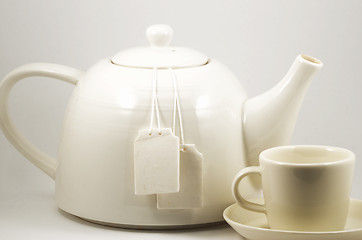 Image showing white teacup and teapot with two blank labels