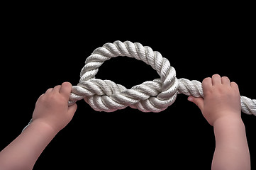 Image showing Baby hands holding overhand knot