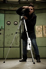 Image showing Woman taking photos in abandoned industrial interior