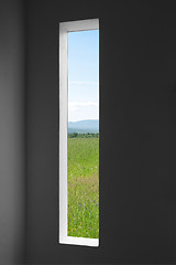 Image showing Summer landscape outside the window of a dark room