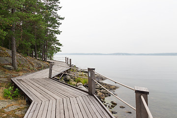 Image showing Rocky lakeshore with wooden pathway