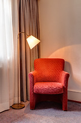 Image showing Red armchair and lamp in the room corner