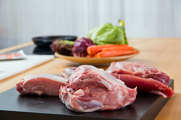 Image showing Meat parts with vegetables at background