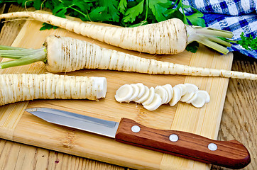 Image showing Parsley root cut with a knife on board