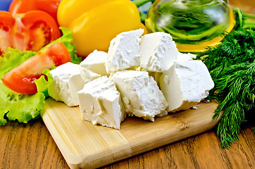 Image showing Feta cheese on the board with vegetables and salad