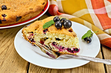 Image showing Pie with black currant on the board with a fork