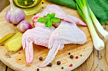 Image showing Chicken wings with garlic on a board